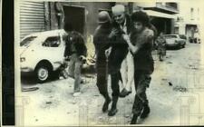 1975 Press Photo Moslem Gunman Carries Elderly Man As They Evacuate Home, Beirut