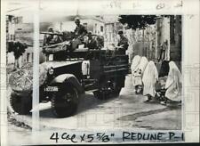 1962 Press Photo Moslem charwomen pass armored vehicle in Oran, Algeria